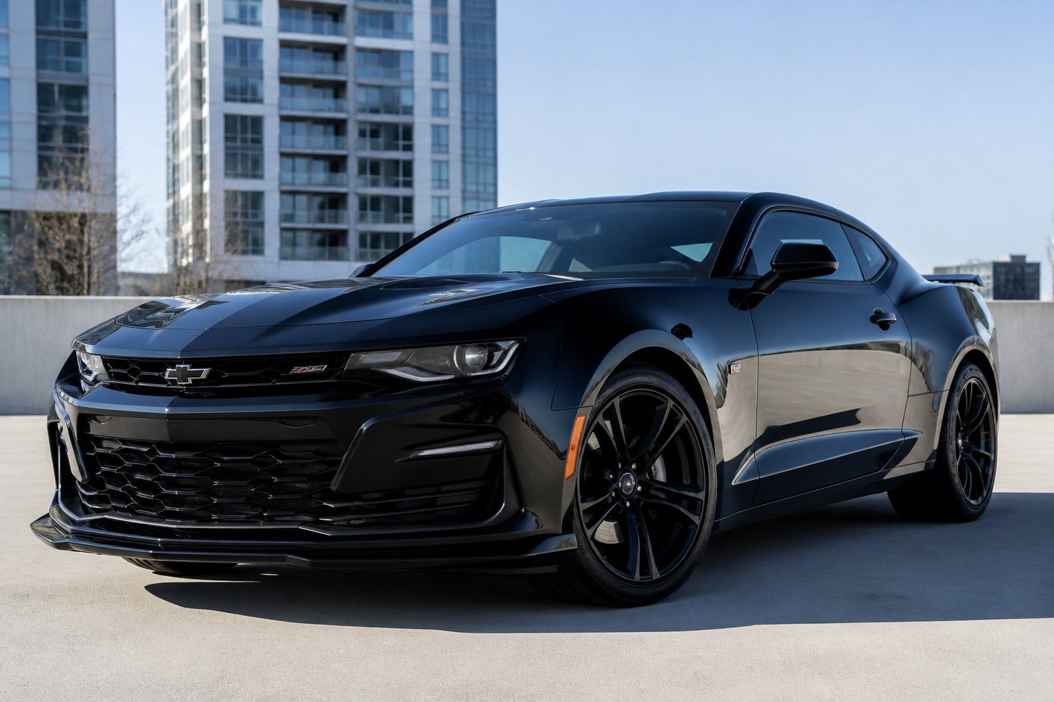 A fifth-generation Chevrolet Camaro parked outdoors in an urban setting on a clear day.