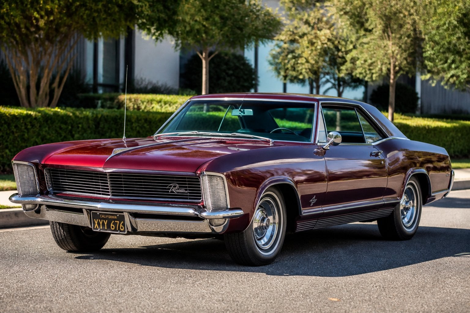 A classic Buick Riviera car parked outdoors on a sunny day with trees and a street in the background.