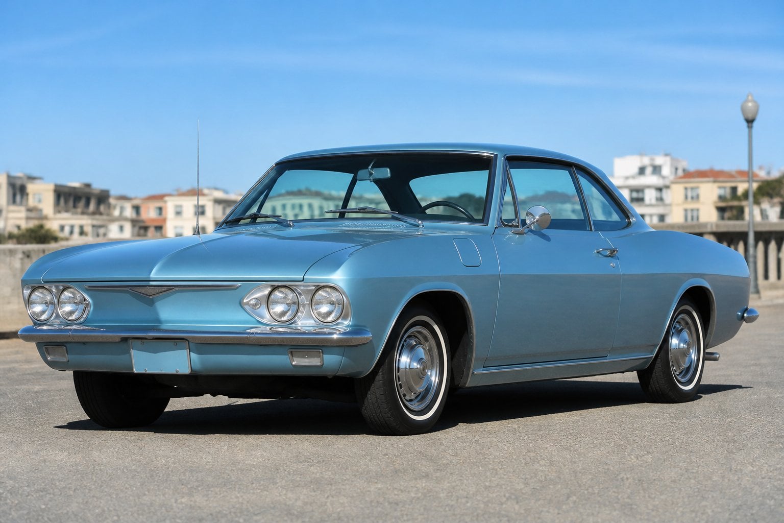A classic Chevrolet Corvair car from the 1960s parked outdoors on a sunny day.