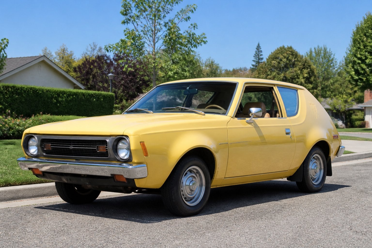 A classic 1970s AMC Gremlin car parked on a suburban street with trees and lawns in the background.