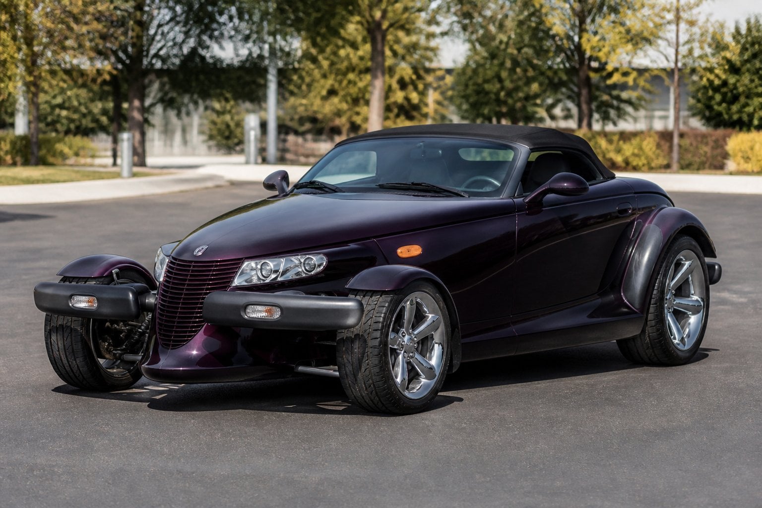A Plymouth Prowler car parked outdoors on an empty street with clear skies.