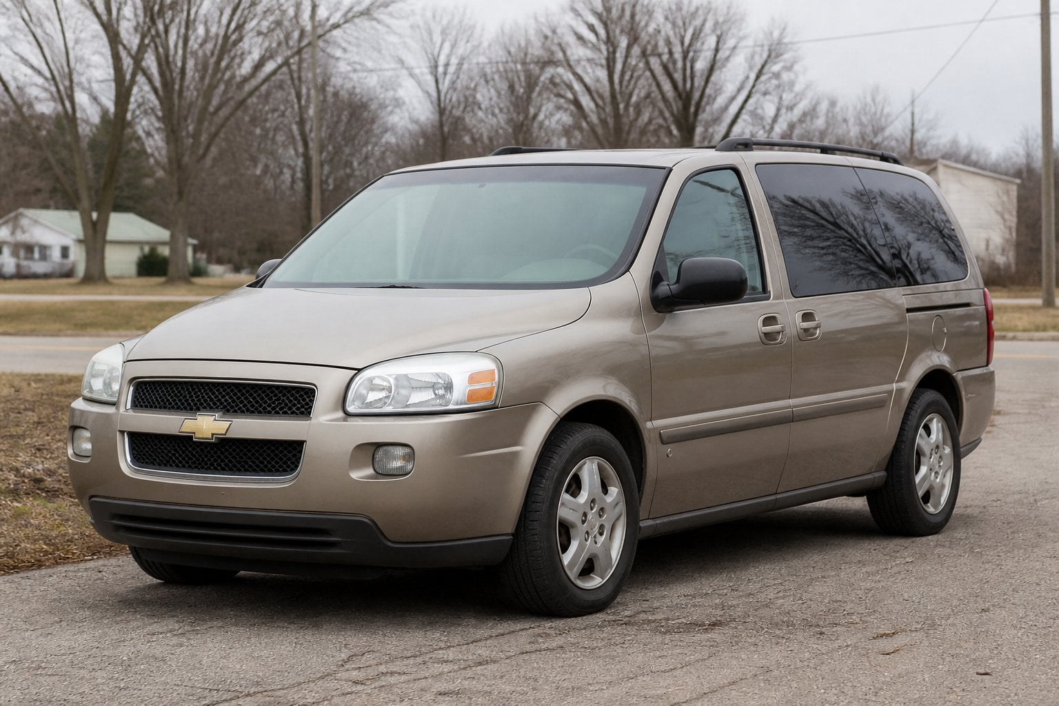 A Chevrolet Uplander minivan parked on a suburban roadside.