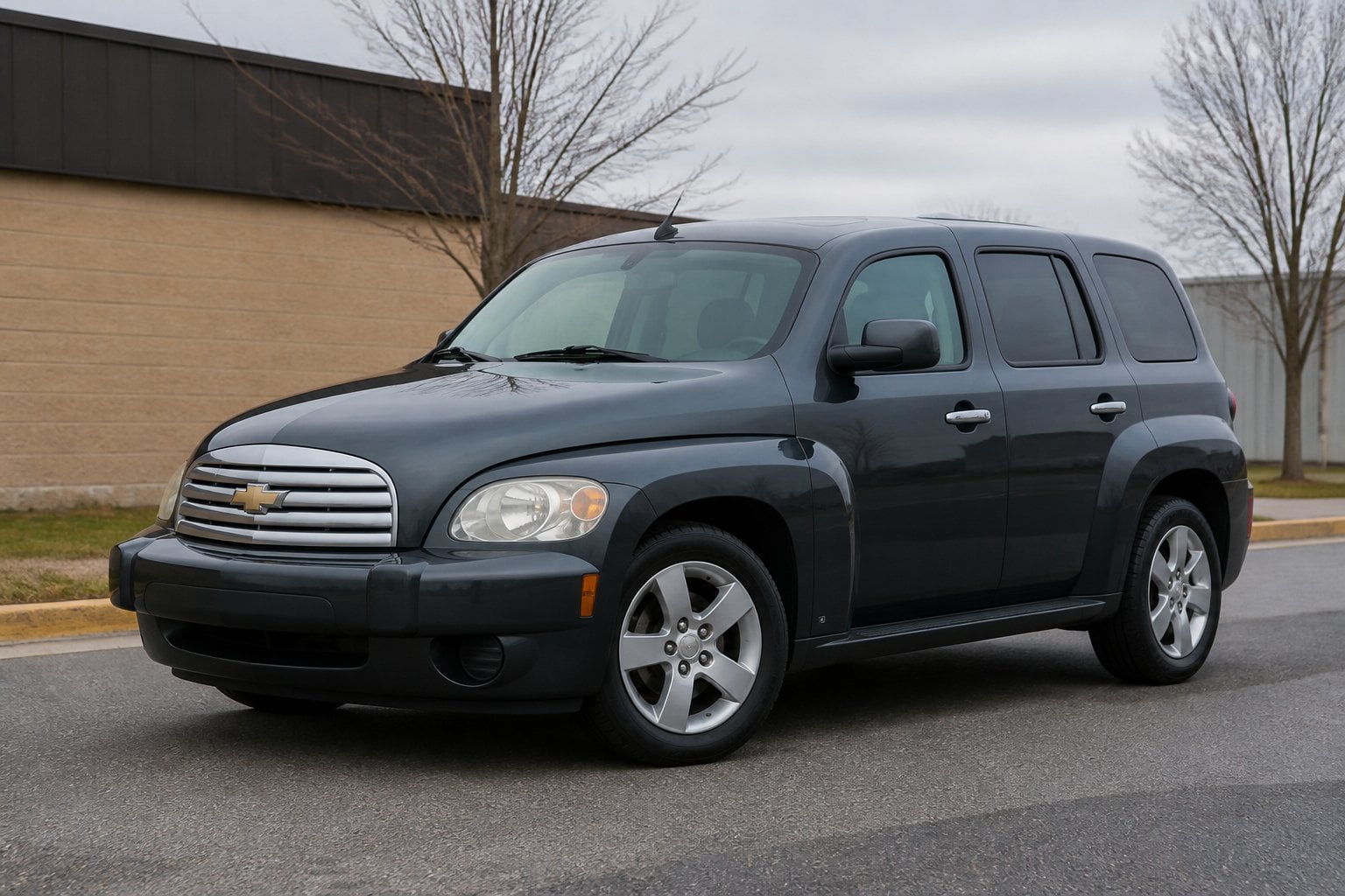 A Chevrolet HHR parked on a quiet roadside in daylight.