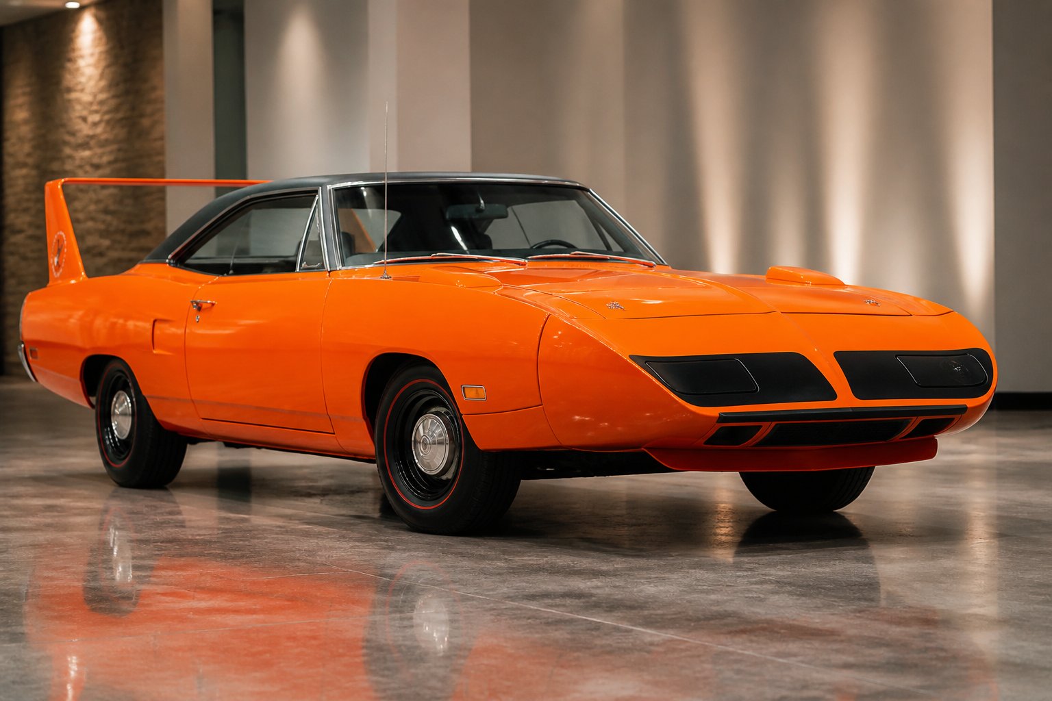 A restored orange 1970 Plymouth Superbird with a large rear wing displayed in a showroom.