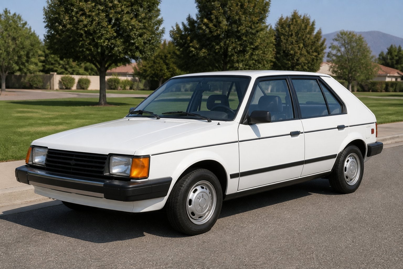A compact late-1980s Dodge Lancer hatchback parked beside a suburban roadside.
