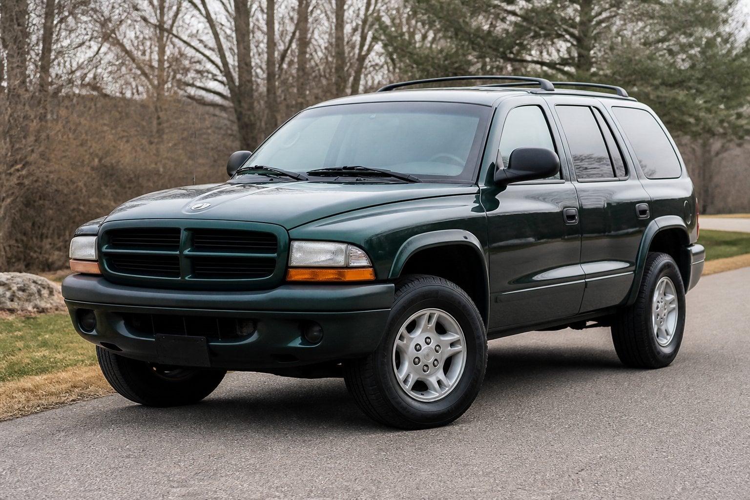 A first-generation Dodge Durango SUV parked on a quiet roadside.