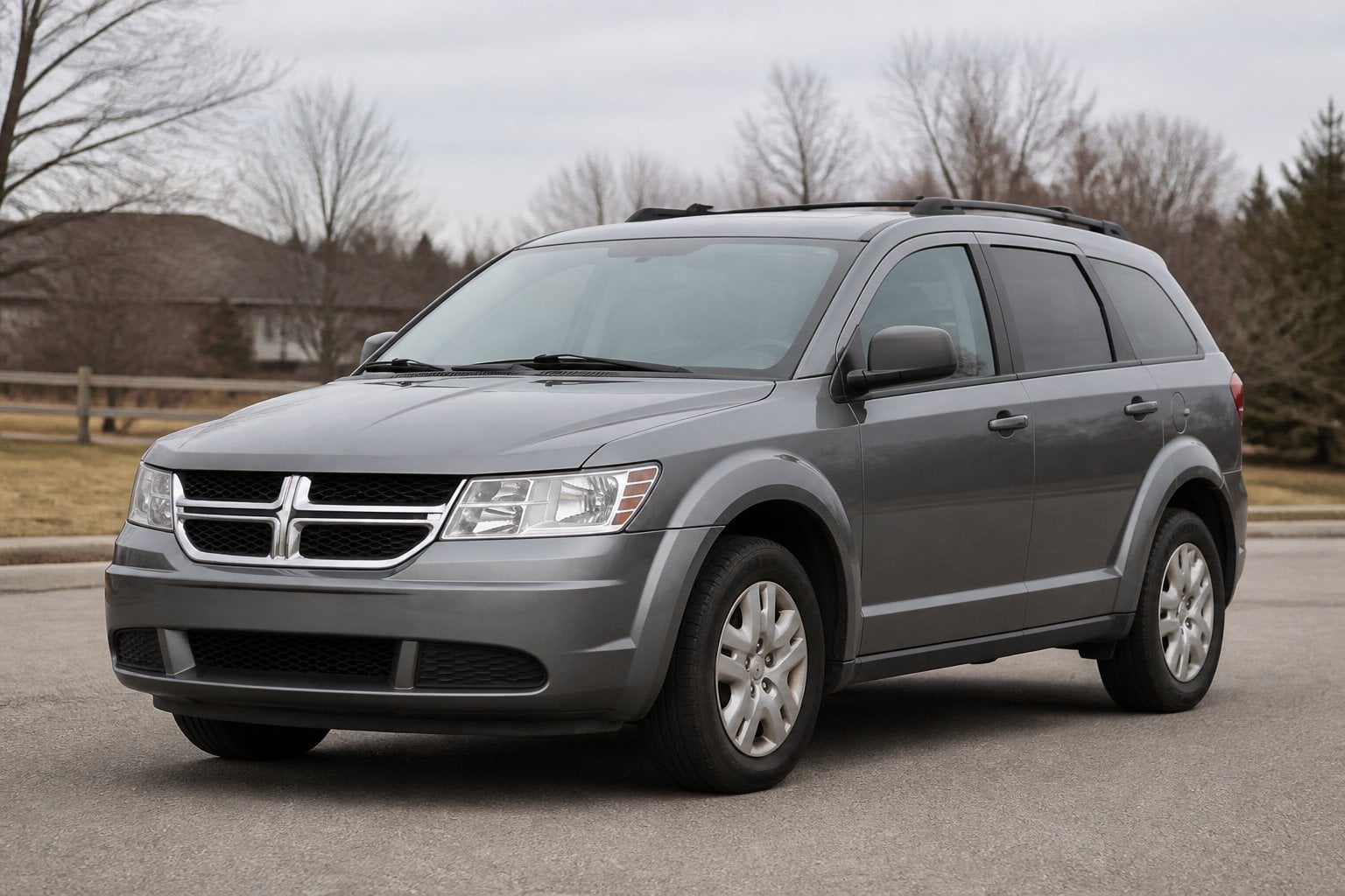 A gray Dodge Journey SUV parked on a suburban roadside.