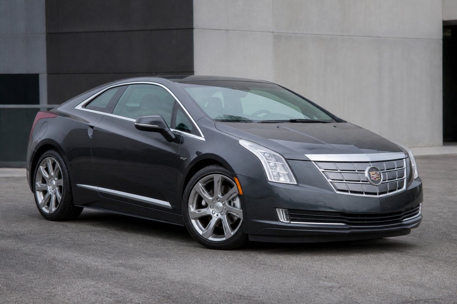 A Cadillac ELR parked on a paved urban surface, viewed from the front side.