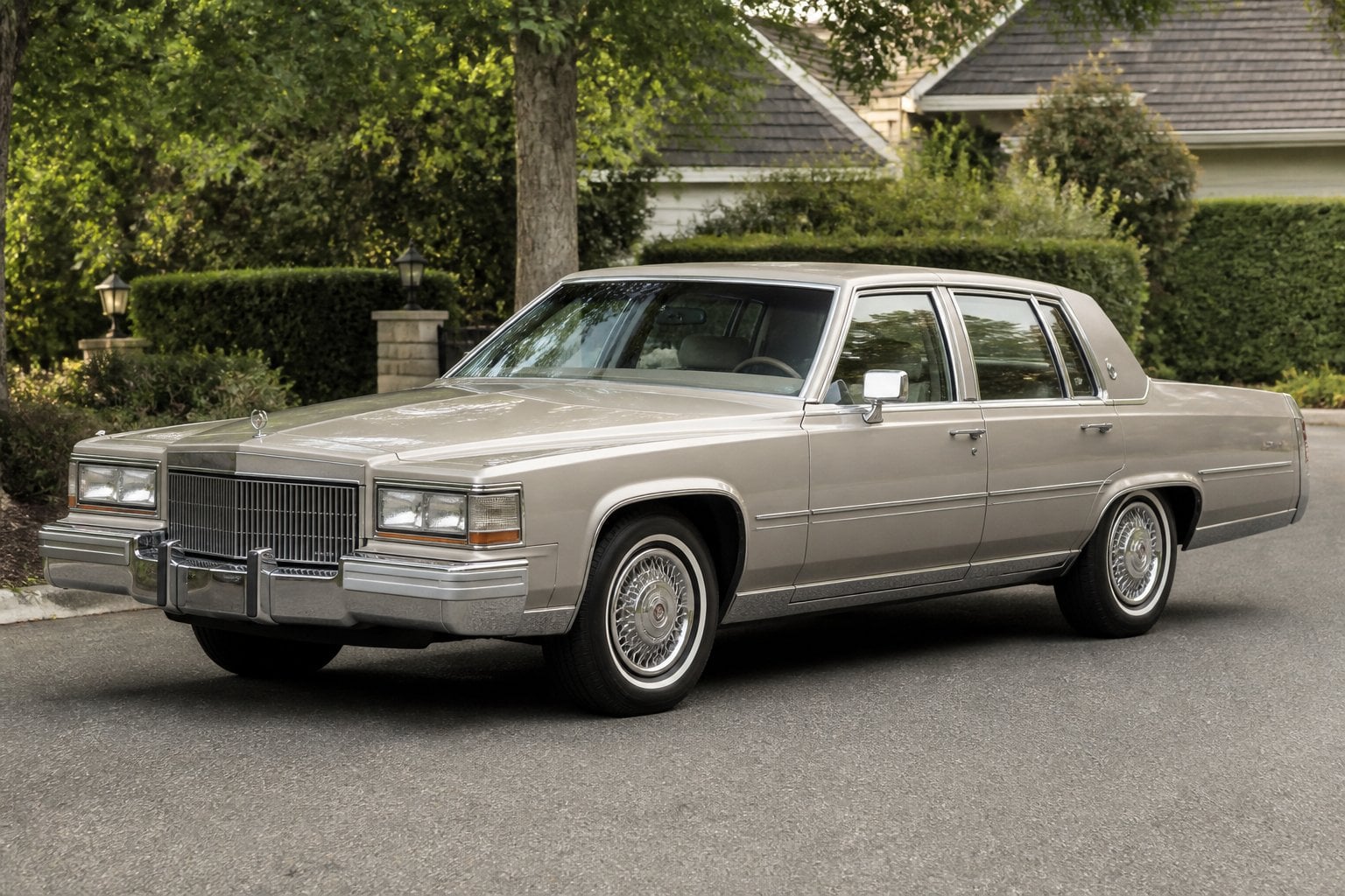A vintage 1981 Cadillac Fleetwood luxury sedan parked on a quiet residential street.