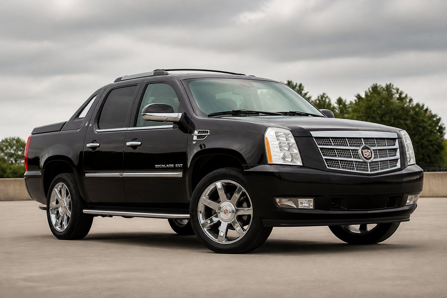 A Cadillac Escalade EXT luxury pickup SUV parked outdoors at a three-quarter front angle.