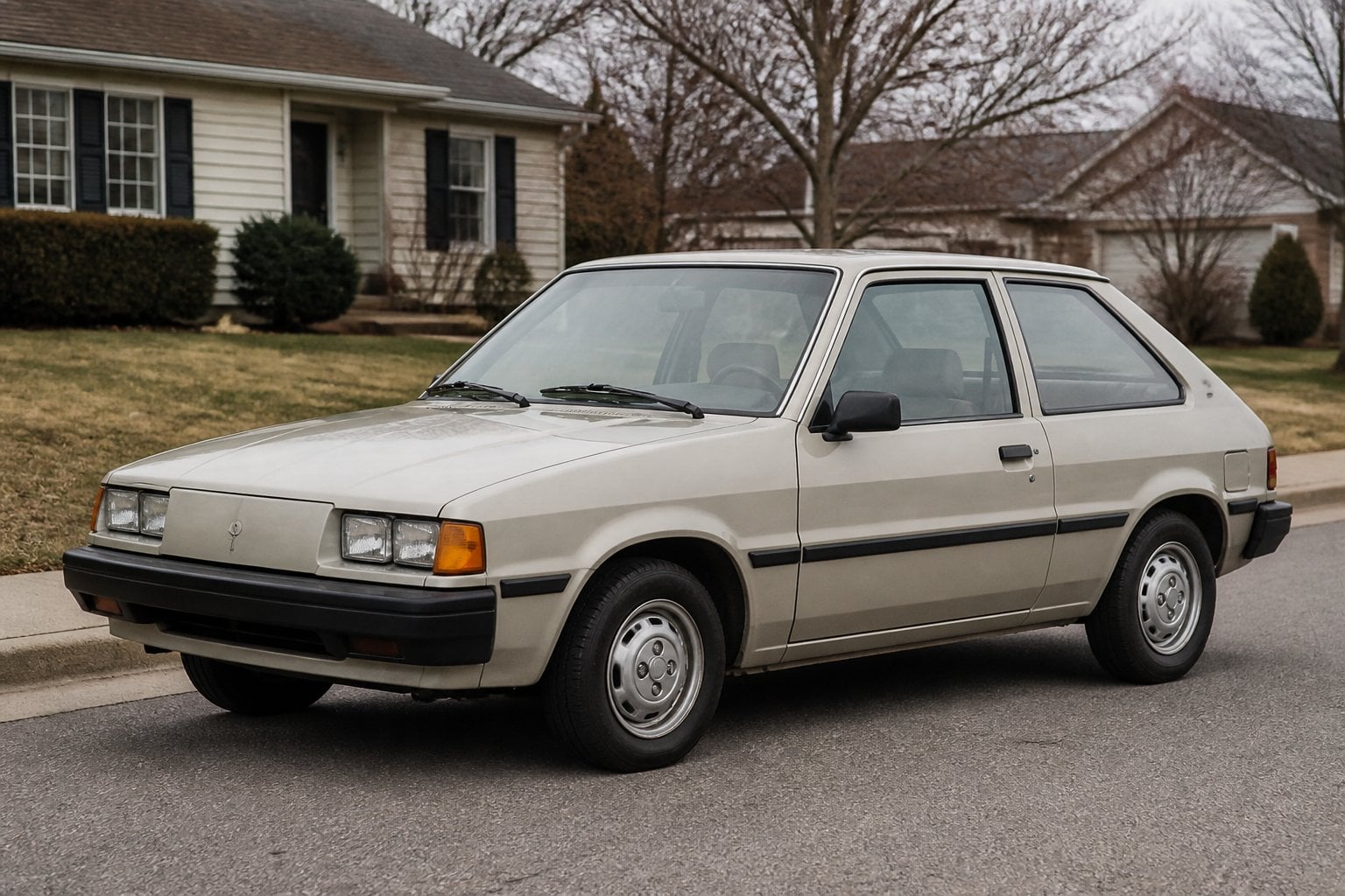 A boxy early-1980s Pontiac T1000 hatchback parked on a quiet suburban street.