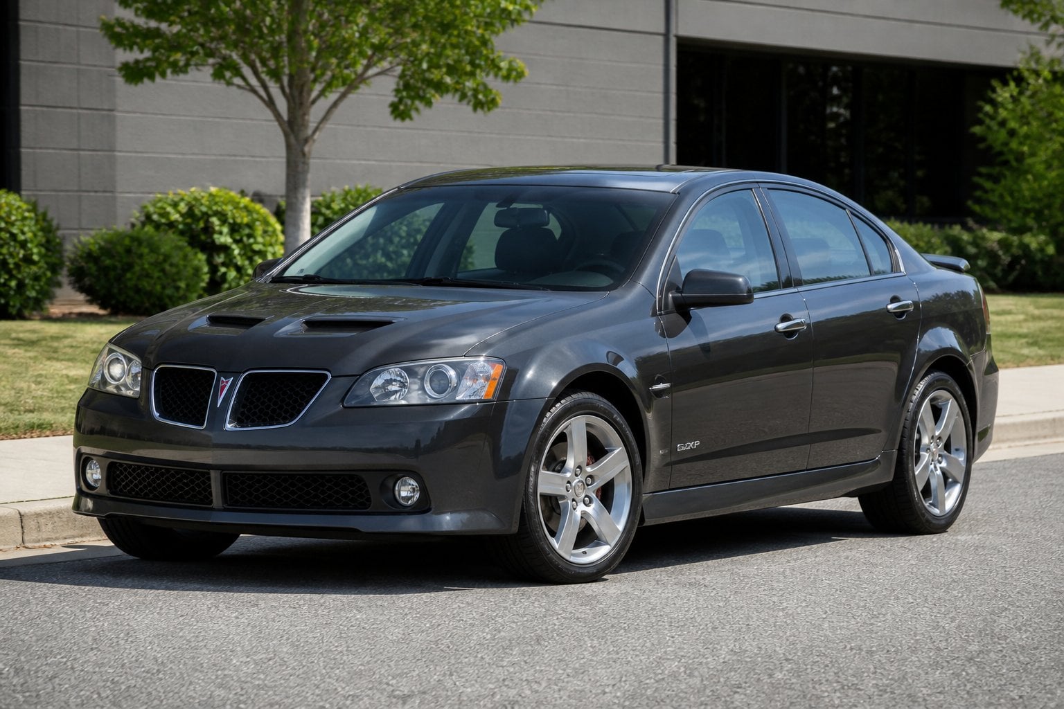 A Pontiac G6 GXP sedan parked on a quiet suburban road.