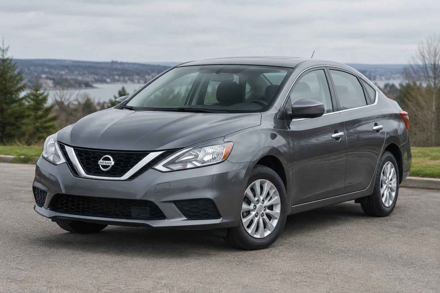 A 2016 Nissan Sentra sedan parked on a quiet roadside.