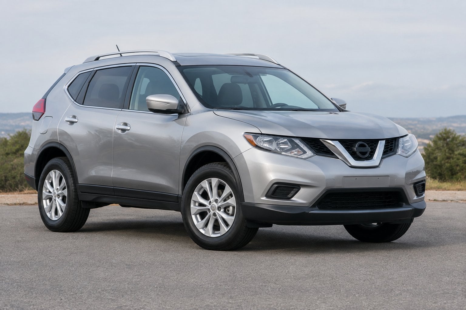 A 2014 Nissan Rogue compact SUV parked outdoors in a three-quarter front view.
