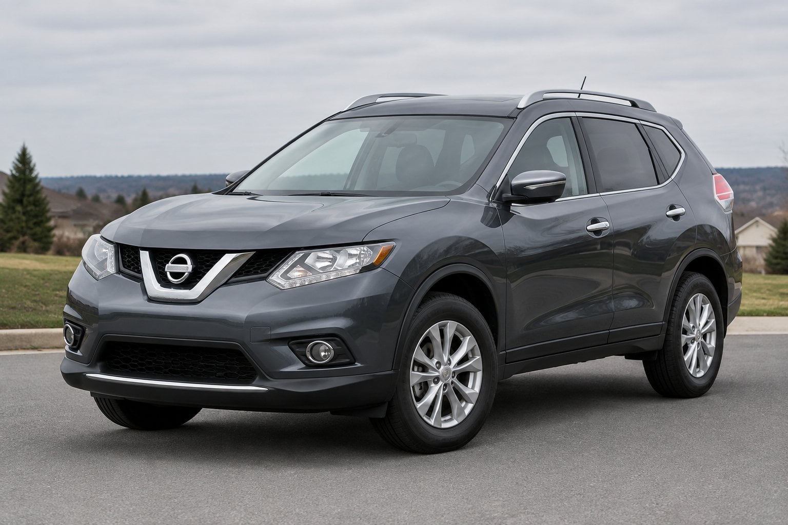 A gray 2016 Nissan Rogue SUV parked on a paved roadside.