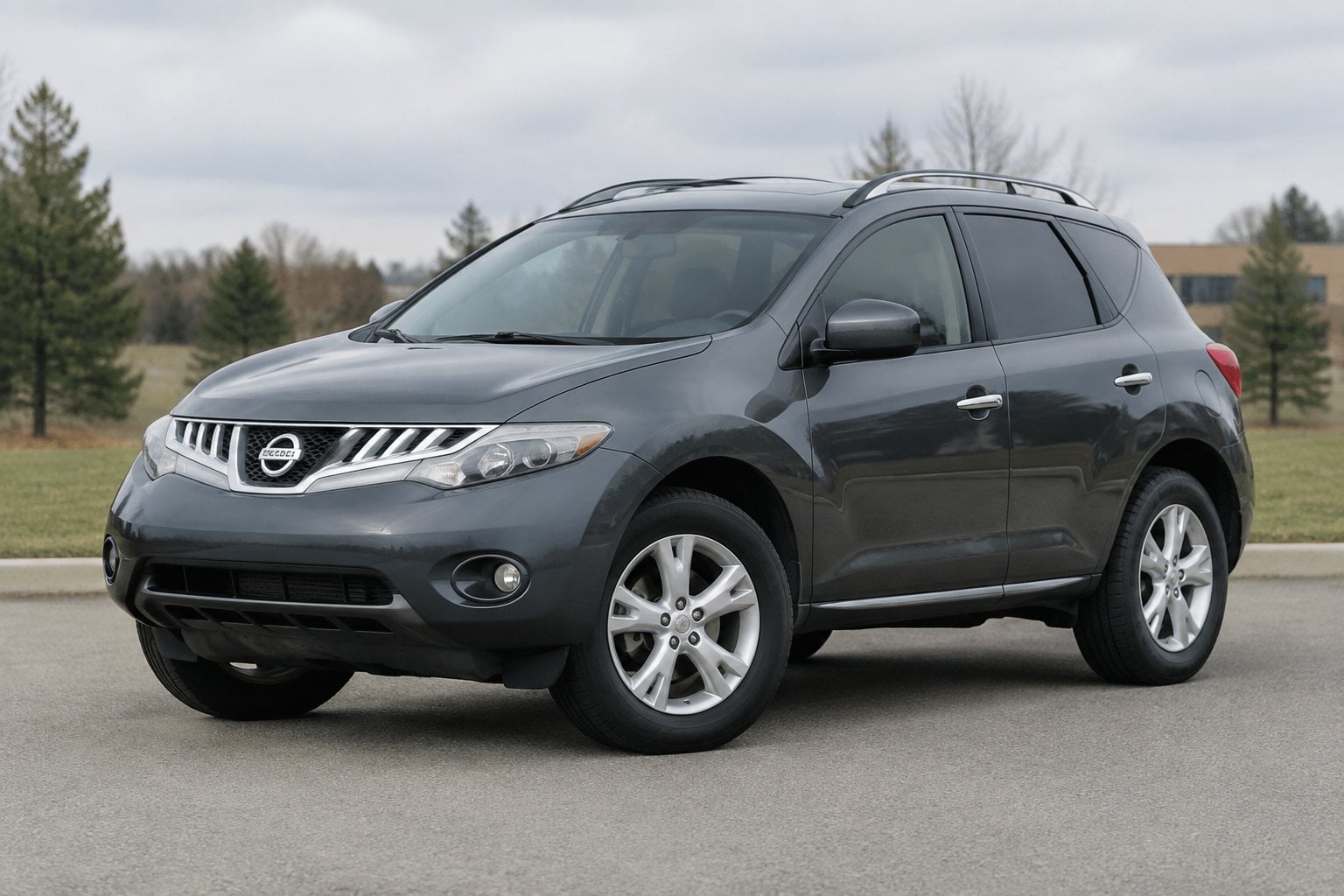 A gray 2011 Nissan Murano parked on a quiet roadside.