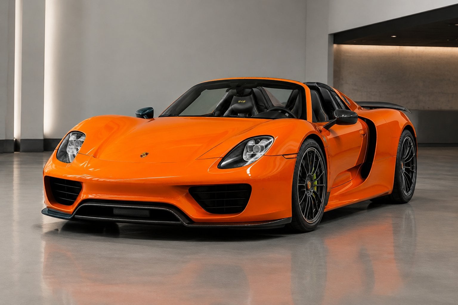An orange Porsche 918 Spyder parked in a modern automotive showroom.
