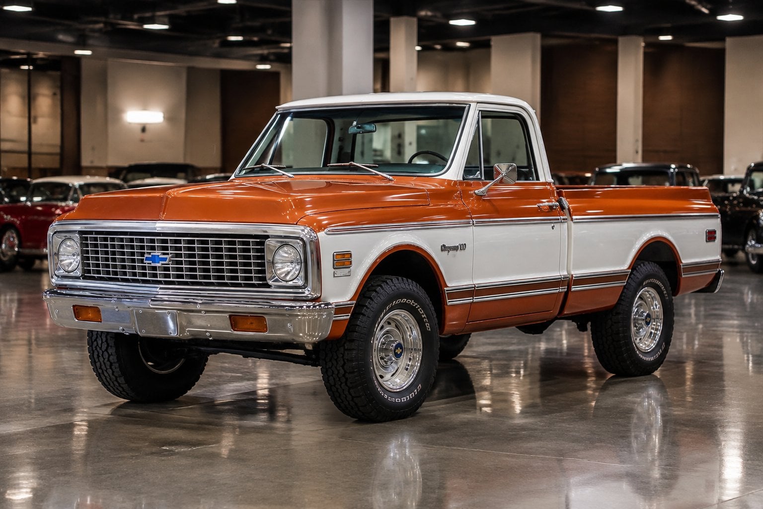 A restored 1972 Chevrolet K10 Cheyenne Super pickup truck displayed in an auction hall.
